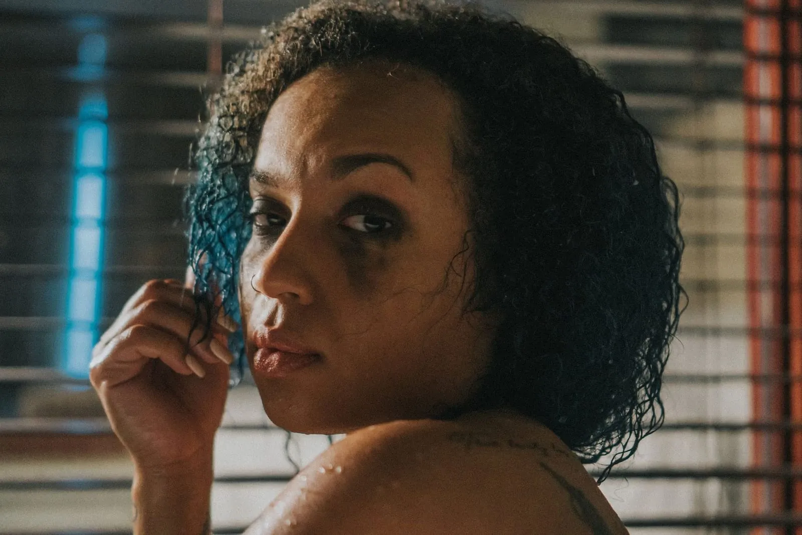 Woman with soaking-wet curls separating a section with her fingers