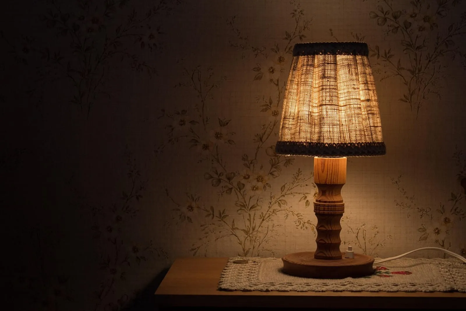Warm bedside lamp glowing in a dim room