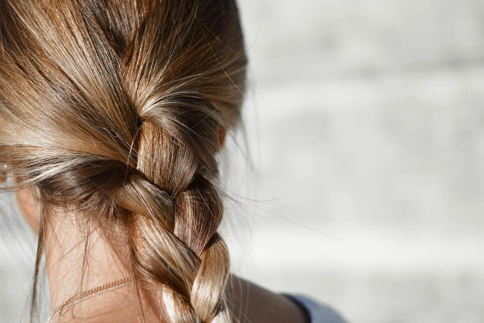 Woman with braided brown hair styled for definition