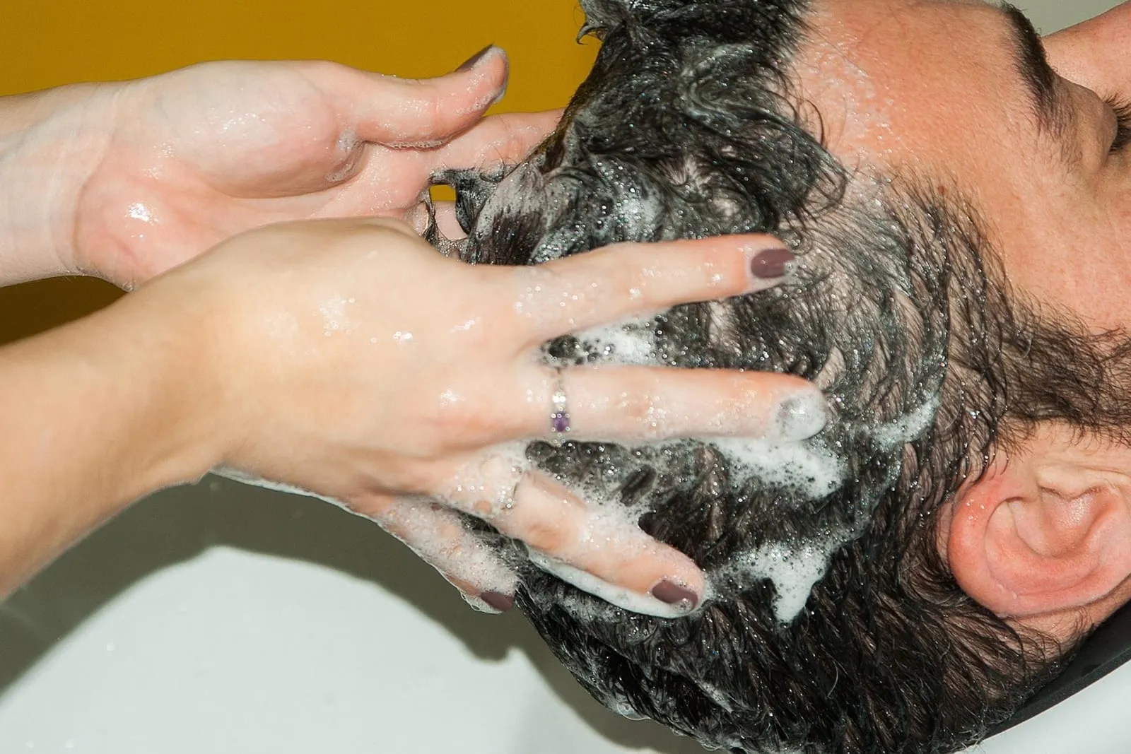 Hairdresser holding a can of styling mousse