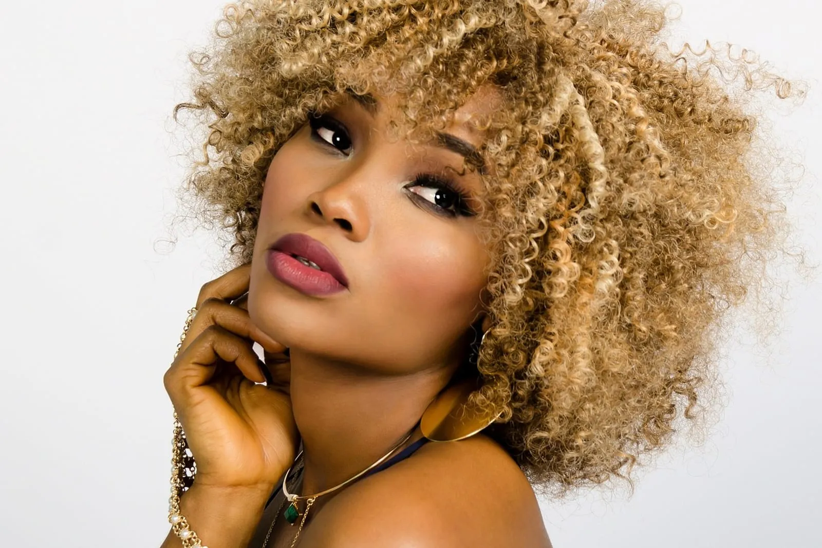 Woman with voluminous curly hair in a close portrait